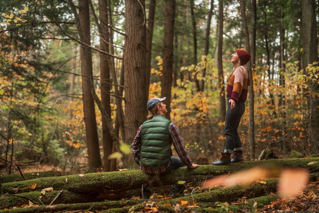Man and woman stand in forest